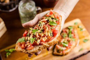 Delicious Bruschetta Toast Cheese Tomato Basil on a Rustic Wooden Plate Baker Artisan Pomodoro