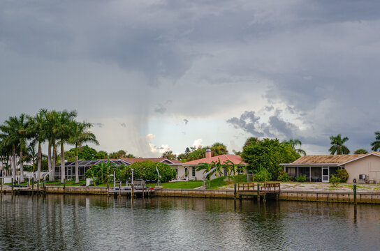 Storm approaching the homes with palm trees