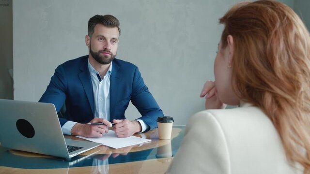 Businessman Interviewing woman job candidate in meeting room. Job HR applicants having an interview with human resource manager jobs interviewing with confident candidate at business firm office.