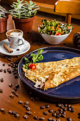 Perfect Breakfast Tapioca Toasted Cheese on a blue plate with Coffee Cinnamon and Salad over a Wooden Table with Coffee Beans