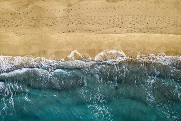 Aerial top view of Patara beach with clear turquoise sea and waves on beach