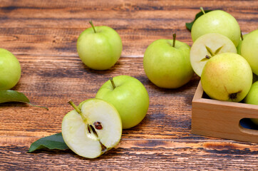 half fruit and apples scattered on a wooden background