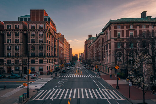 A city street with tall buildings at sunset - Amsterdam Avenue from Columbia University, in Morningside Heights, New York City