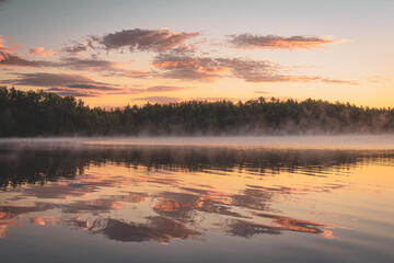 Obraz na płótnie Canvas Fog on a lake at sunrise, at Baxter State Park, Maine