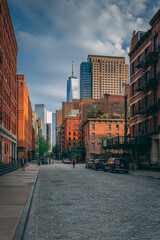 Cobblestone street with view of the World Trade Center, in Tribeca, Manhattan, New York City