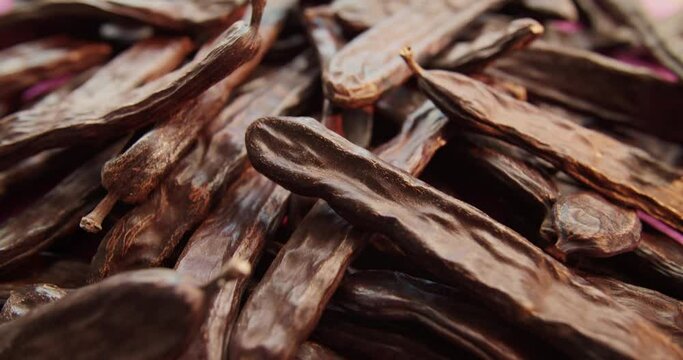 Carob dried fruit close-up. Advertising of food does not contain caffeine, wholesome food and drinks from the carob