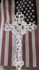 white cross with American flag background