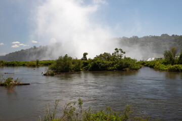 The white mist and water splash created by the Iguazu falls in Garganta del Diablo, in Misiones,...