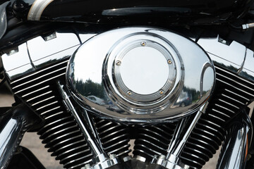 Shiny chrome motorcycle parts close-up. A large tourist motorbike. Engine cylinders and cooling...