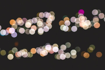 Blurry lights (bokeh effect) of the phones of the public attending a great concert in a stadium