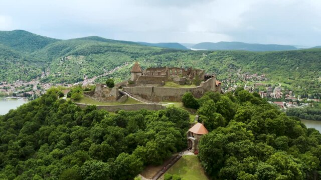 Visegrad, Hungary - Aerial panoramic view of the remains of the beautiful High Castle or Upper Castle of Visegrad with the Danube bend and the city of Nagymaros in the background.