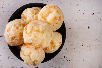 bowl of cheese breads on a white marble