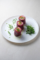 Menu for the restaurant: salad of herring, beetroot and vegetables, served in the form of rolls.