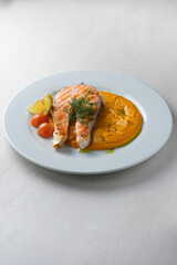 Menu for the restaurant: Trout steak served with carrot and potato puree.