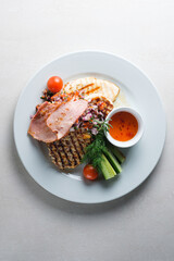 Menu for the restaurant: a plate with brisket, pork, chicken, vegetables and sauce.