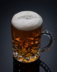 
Glass mug with beer on gray gradient background