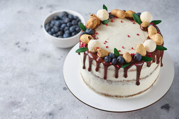 Honey sponge cake with salted caramel and peanuts. Cake with cream cheese cream and peanut butter. Delicious natural and beautiful festive dessert.
