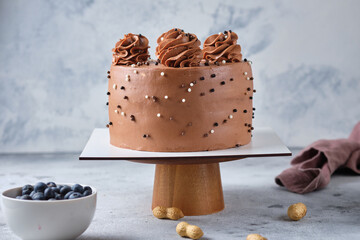 Chocolate sponge cake stuffed with salted caramel and peanuts. Cake with cream cheese chocolate cream.