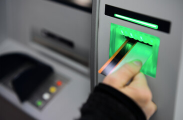 Person hebt Geld am Bankautomat ab Bargeld abheben mit Bankkarte am Geldautomat Kreditkarte
