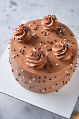 Chocolate sponge cake stuffed with salted caramel and peanuts. Cake with cream cheese chocolate cream.