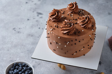 Chocolate sponge cake stuffed with salted caramel and peanuts. Cake with cream cheese chocolate cream.