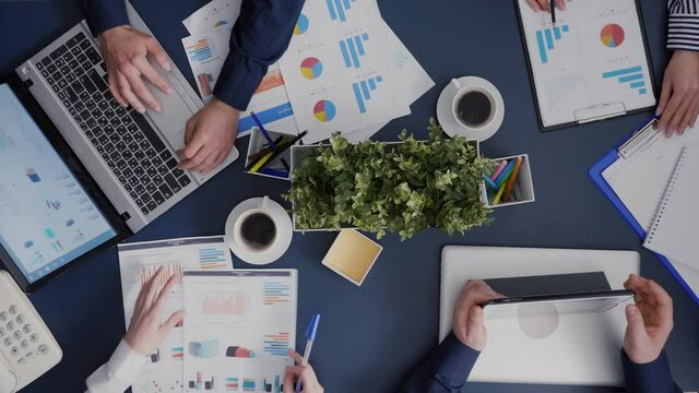 Top view timelapse of business teamwork working analyzing company financial accounting paperwork in startup office. Group of managers planning corporate partnership brainstorming ideas