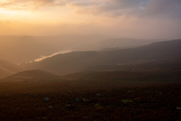 Ladybower water reserve hidden behind the magical evening fog at sunset in September, hiking trail in Peak District, England, UK