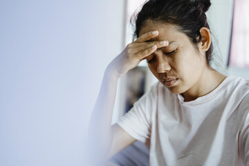 Fototapeta premium young asian woman hold the head with hand due to headache