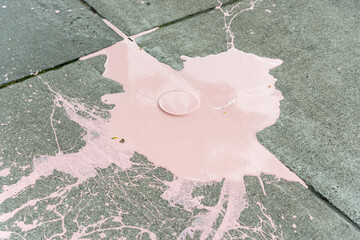 big mess: can of pink house paint on concrete - watch your step