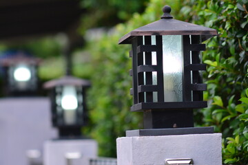 Vintage lamps adorned on the fence in front of the house