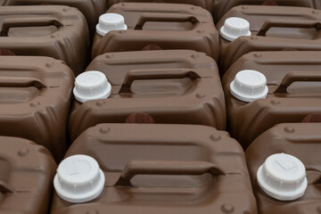 Fototapeta premium Bottles cans Professional household paint laque, Liquid in the hardware warehouse store. Brown Plastic canisters with red white cork cap.