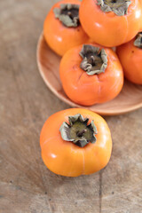 Ripe ruddy crisp persimmons in autumn
