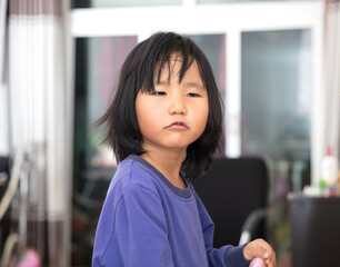 Cute little chinese girl looking to the camera