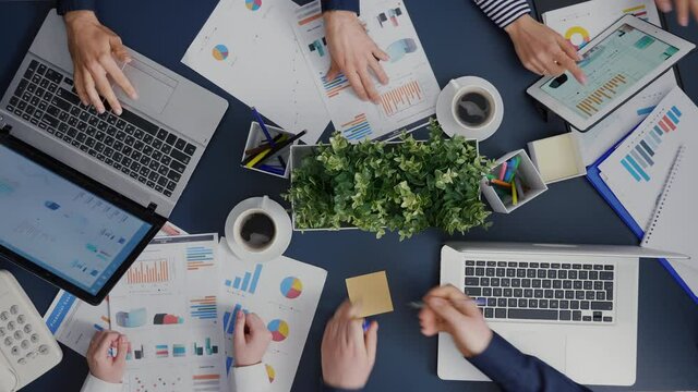 Top view of businessman putting to do sticky notes on desk table explaining financial paperwork working at company investment in startup office. Businesspeople brainstorming management strategy ideas