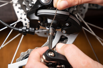 Fototapeta na wymiar adjustment of gear shifting on a bicycle with a hexagon