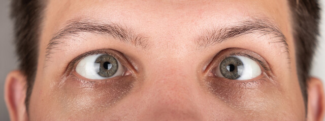 Fototapeta premium strabismus of a man's eyes close-up panorama