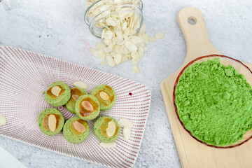 Biskut Mazola kacang hijau is a green peas cookies with background decoration. A vertical top view