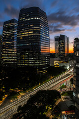 Fototapeta na wymiar aerial view of commercial offices buildings on Juscelino Kubitschek Avenue, with the sunset in the background in the south side of Sao Paulo, city