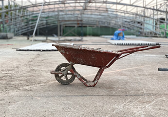 The old condition cart with stain for transporting cement. For construction site in the outdoor.