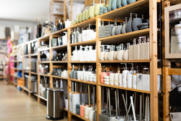 Variety of bathroom accessories displayed on shelving in household goods store. Concept of organizing comfortable home space