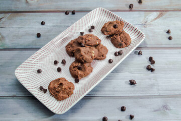 Chocolate crunchy cookies with background decoration. Selective focus.