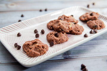 Chocolate crunchy cookies with background decoration. Selective focus.