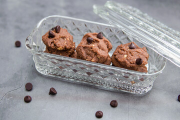 Chocolate crunchy cookies with background decoration. Selective focus.
