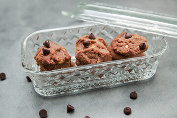 Chocolate crunchy cookies with background decoration. Selective focus.