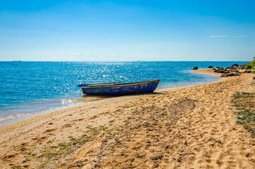 Fototapeta na wymiar A fishing boat is standing on the seashore.A deserted sea beach.