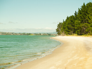 Scenic beach leading along harbor edge