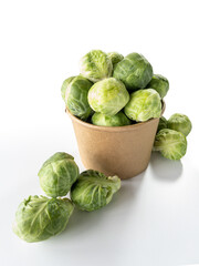 brussels sprouts in a cardboard pot on white background.