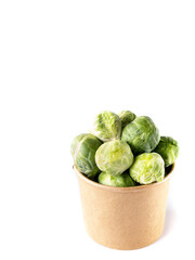brussels sprouts in a cardboard pot on white background