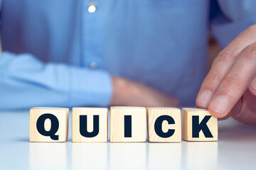 Word QUICK made with wood building blocks