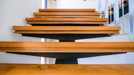 Steel staircase decorated with teak wood. Concept for design, interior and construction.